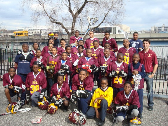 Head Coach Simon Cataldo (far right) with a portion of the Frederick Douglass Academy Middle School Lacrosse squad. Head Coach Simon Cataldo (far right) with a portion of the Frederick Douglass Academy Middle School Lacrosse squad.