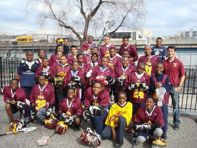 Head Coach Simon Cataldo (far right) with a portion of the Frederick Douglass Academy Middle School Lacrosse squad.