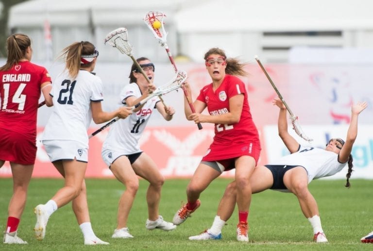 England's Olivia Hompe(22) shows determination against the USA at the 2017 FIL Rathbones Women's Lacrosse World Cup at Surrey Sports Park, Guilford, Surrey, UK, 15th July 2017