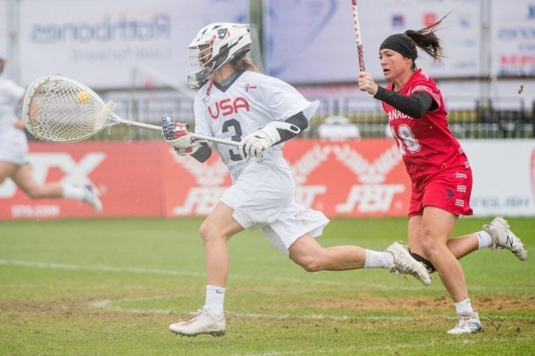 USA's GK, Devon Wills outruns Canada's Crysti Foote(18) at the 2017 FIL Rathbones Women's Lacrosse World Cup at Surrey Sports Park, Guilford, Surrey, UK, 15th July 2017